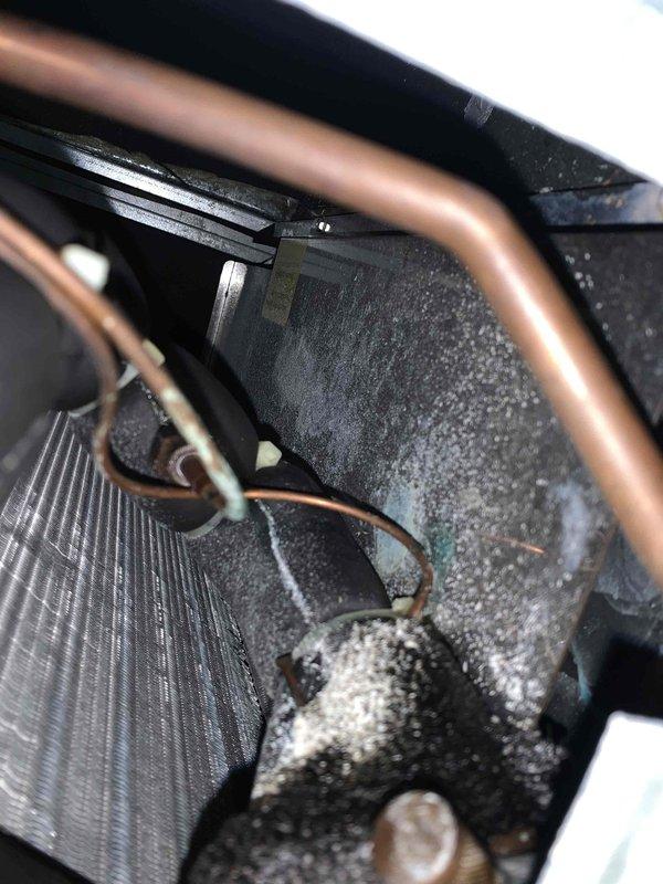 Performed routine cooling maintenance on Unico air handler system. Conducted electrical diagnostics using multimeter, verified system voltage at 440VAC. Inspected evaporator coil and internal components, noting significant dust and debris accumulation on heat exchanger surfaces and blower assembly requiring attention for optimal airflow and system efficiency.