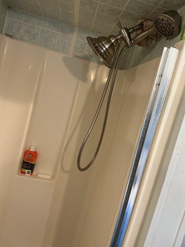 Completed plumbing inspection of residential bathroom fixtures and components. Evaluated dual showerhead system with fixed wall-mounted and handheld units, confirming proper operation and secure mounting of chrome fixtures. Inspected fiberglass shower stall for water damage, deterioration, and proper drainage function. Examined toilet installation, verifying secure mounting, proper flush mechanism operation, and absence of leaks at base and tank connections. Assessed bathroom cabinetry and fixtures for water damage or moisture intrusion. Renewed shower filtration system components to maintain water quality and fixture longevity. All plumbing fixtures found in good working condition with no immediate repair needs identified.