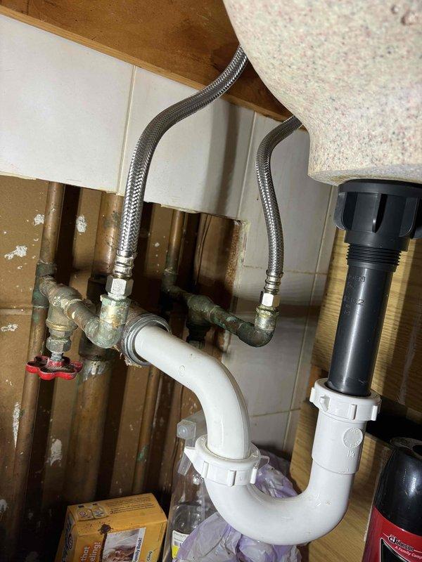 Replaced two bathroom faucets and connected new flexible braided supply lines to existing shut-off valves. Verified proper drainage through P-trap assembly and tested for leaks at all connection points.