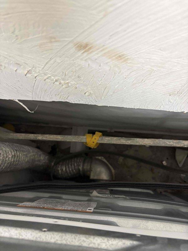 Conducted on-site evaluation of existing 20-year-old propane furnace system with air conditioning for replacement estimate. Inspected furnace control board, terminal connections, and wiring configuration to assess current system condition and compatibility requirements for new equipment installation. Documented existing system components including control board circuitry, terminal block connections, and mechanical assembly beneath floor structure to determine proper sizing and specifications for replacement HVAC system.