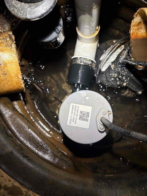 # Sump Pump Service Call

Responded to service call for non-operational sump pump. Upon inspection, determined the float switch was stuck in the down position, preventing the pump from activating. Freed the float mechanism and verified proper movement and pump operation. Per company authorization code AGDZ, no charge was applied to this service call. Documented equipment condition with photographs showing the sump pump assembly, surrounding plumbing components, and mechanical room environment.