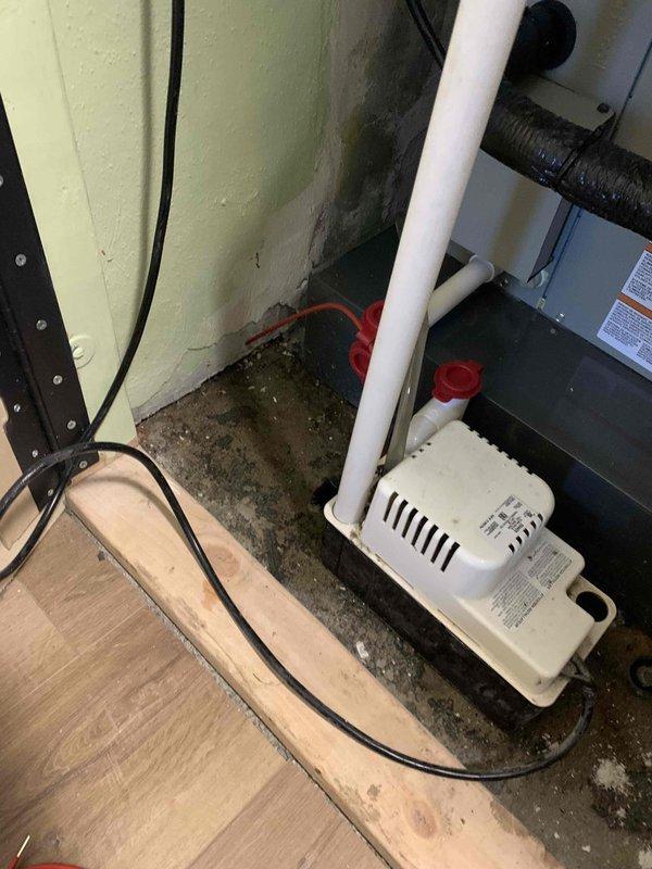 Responded to emergency no-heat call for 3-year-old furnace system. Upon inspection, discovered condensate pump failure preventing furnace operation due to safety switch activation. The pump had experienced overflow conditions, evidenced by significant water staining and moisture accumulation on concrete floor surrounding unit. Cleared condensate line blockage, tested pump operation, and verified proper drainage function. Reset safety switch, restored furnace to normal heating operation, and confirmed system cycling properly before departure.