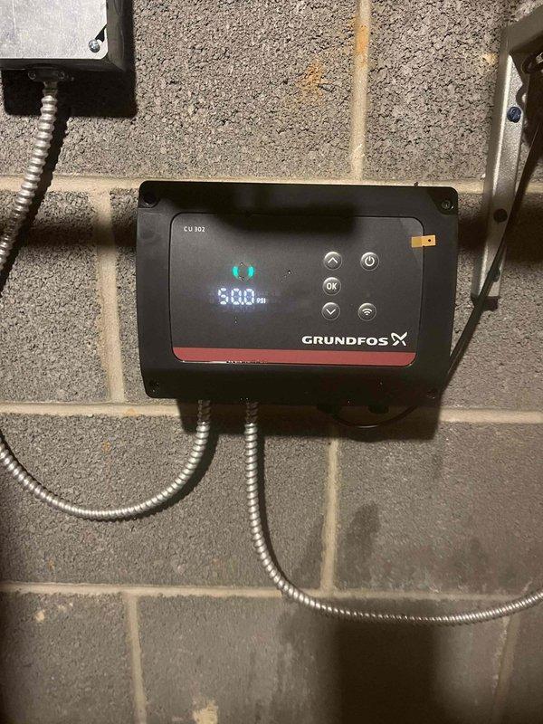 Returned to property to replace a failed circulator pump under manufacturer warranty. Removed the defective Grundfos X series pump and control unit from the hydronic heating system and installed a new replacement unit. Connected the new pump to the existing copper piping, expansion tank assembly, and electrical conduit. Verified proper operation of the digital control panel, pressure gauge readings, and system flow. Tested all connections for leaks and confirmed the heating system was functioning correctly with the new pump operational.
