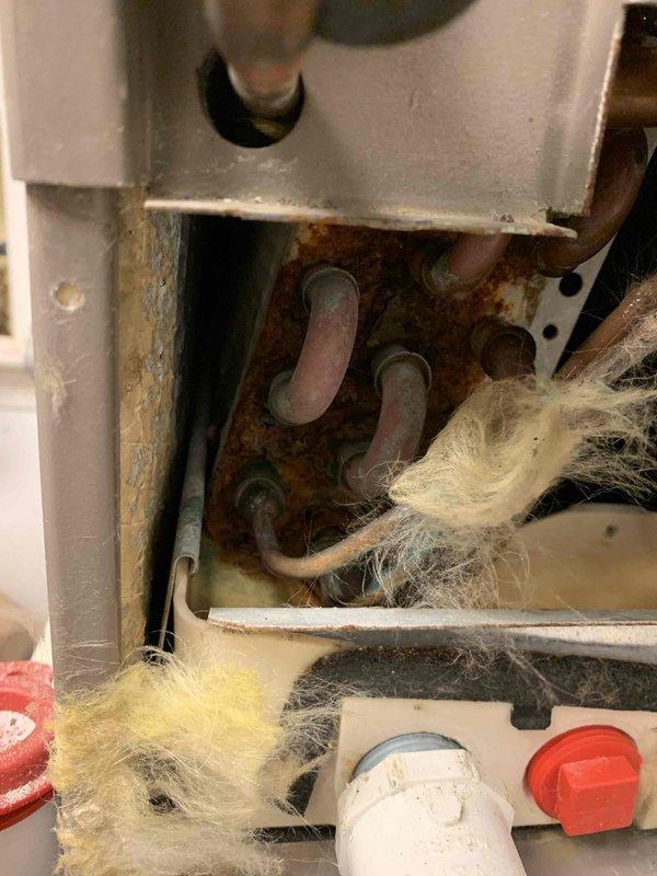 Responded to no-cooling call where system would not turn on. Upon arrival, found outdoor unit with blown fuses due to severely corroded electrical connections and significant debris accumulation restricting airflow around internal components. Replaced fuses, cleaned excessive lint and dust buildup from blower assembly, and treated corroded metal housing and mounting components. Verified proper voltage readings with multimeter after repairs. System restored to normal cooling operation with all safety controls functioning properly.