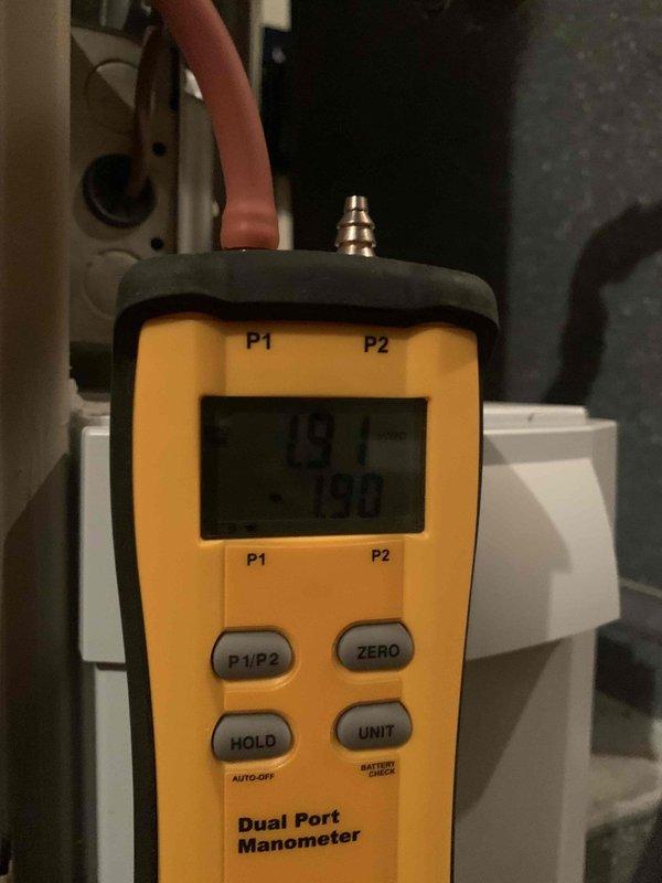 Responded to no heat call on 13-year-old furnace. Upon arrival, performed diagnostic testing using digital manometer to measure gas pressure and airflow parameters. Inspection revealed significant corrosion and mineral buildup on the pressure switch assembly and associated rubber hose connections. The deteriorated condition of the pressure switch hose and clamp assembly was documented, showing crusty deposits indicating prolonged exposure to condensate and moisture. Flow sensor connections exhibited advanced wear consistent with unit age. Testing confirmed pressure switch operation was compromised due to component degradation. Recommended replacement of pressure switch assembly and associated hardware to restore proper furnace operation and ensure safe heating system function.