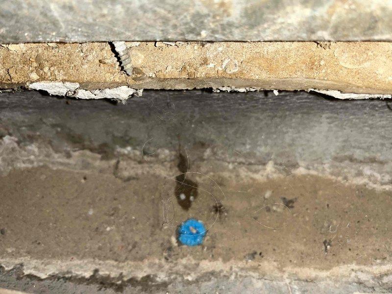 Performed camera inspection of slab ductwork to investigate suspected water intrusion from backing downspouts. Documentation revealed significant deterioration of concrete foundation materials with extensive cracking, separation, and moisture damage. Inspection confirmed presence of water infiltration into ductwork system with visible structural displacement and efflorescence indicating chronic moisture exposure requiring further remediation.