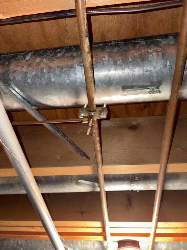 Completed HVAC replacement estimate for residential property with 40-year-old furnace and 15-20 year-old air conditioning system. Customer inquired about Trane equipment options and expressed interest in humidifier replacement. Both existing systems currently operational; documented existing ductwork, outdoor condensing unit, refrigerant lines, and condensate drainage configuration through detailed site photography.