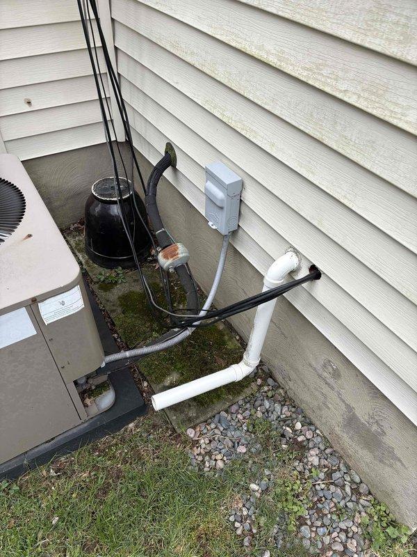 Completed HVAC replacement estimate for residential property with 40-year-old furnace and 15-20 year-old air conditioning system. Customer inquired about Trane equipment options and expressed interest in humidifier replacement. Both existing systems currently operational; documented existing ductwork, outdoor condensing unit, refrigerant lines, and condensate drainage configuration through detailed site photography.