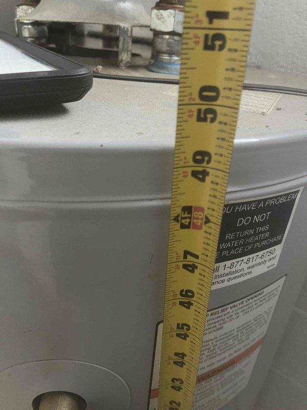 Completed water heater upgrade from traditional tank-style unit to tankless system. Removed existing cylindrical tank water heater and installed new Lochinvar tankless unit with proper copper piping connections, valve assembly with temperature controls, and integrated expansion tank. Ensured all connections met code requirements and system was tested for proper operation and leak-free performance.