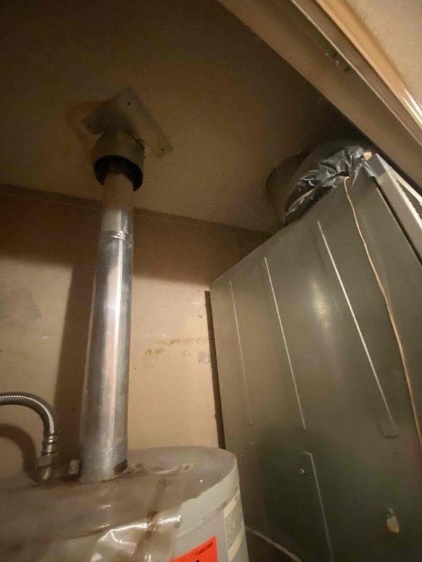 Completed HVAC system evaluation for replacement estimate at residential property with 28-year-old furnace and 4-5 year-old air conditioning system located in utility closet. Documented existing equipment configuration including aging furnace unit with visible wear, operational water heater with proper venting, and newer AC condenser. Assessed closet space dimensions, clearances, and existing ductwork connections to determine replacement equipment specifications and installation requirements for updated high-efficiency HVAC system.
