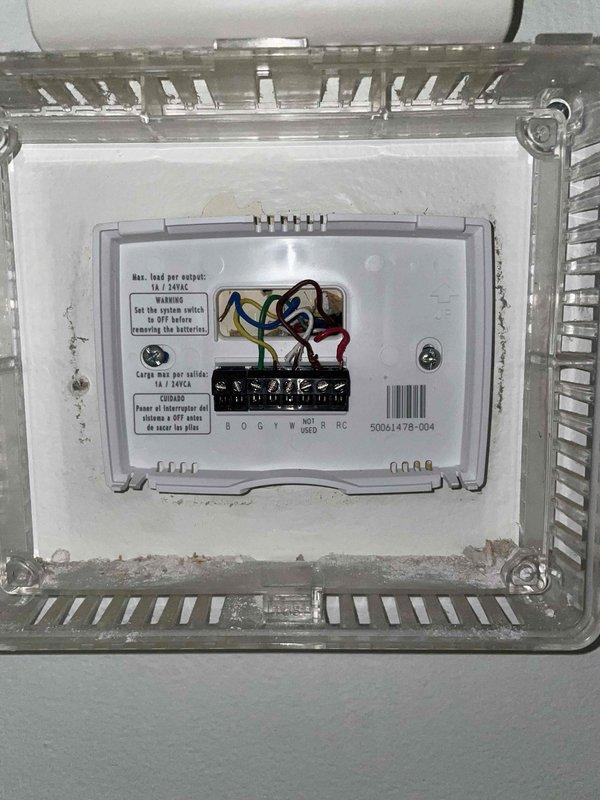 Responded to callback for thermostat installed in November with reported cooling malfunction while heating operated normally. Inspected thermostat wiring at air handler terminal strip and verified all connections were secure and properly terminated to correct terminals. Tested system operation in cooling mode and confirmed air conditioning unit engaged properly with no wiring issues found.