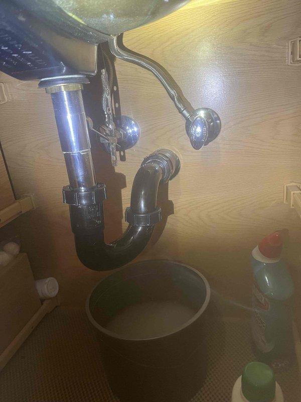 Responded to customer report of water rising in toilet bowl when using bathroom sink faucet. Upon inspection, identified failed wax ring gasket at toilet base allowing improper drainage interaction between fixtures. Removed and replaced deteriorated wax ring seal showing visible wear and compromised integrity. Inspected under-sink plumbing connections including P-trap assembly and tailpiece for proper drainage flow and verified no blockages or leaks present. Tested system after repairs to confirm toilet and sink now draining independently without cross-fixture water backup issues.