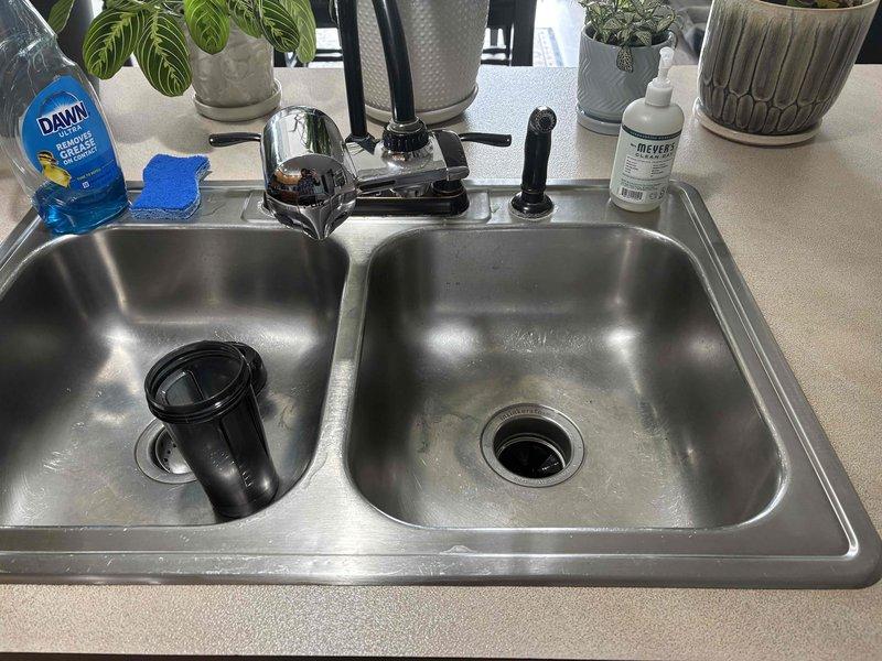 Replaced kitchen sink faucet with new single-handle pull-down model. Installed updated supply line connections under sink with braided stainless steel flexible hoses and new shut-off valve assembly. Customer advised that water hammer issue in lines and condensation/rust concerns on water heater unit will require additional evaluation and separate repair service.