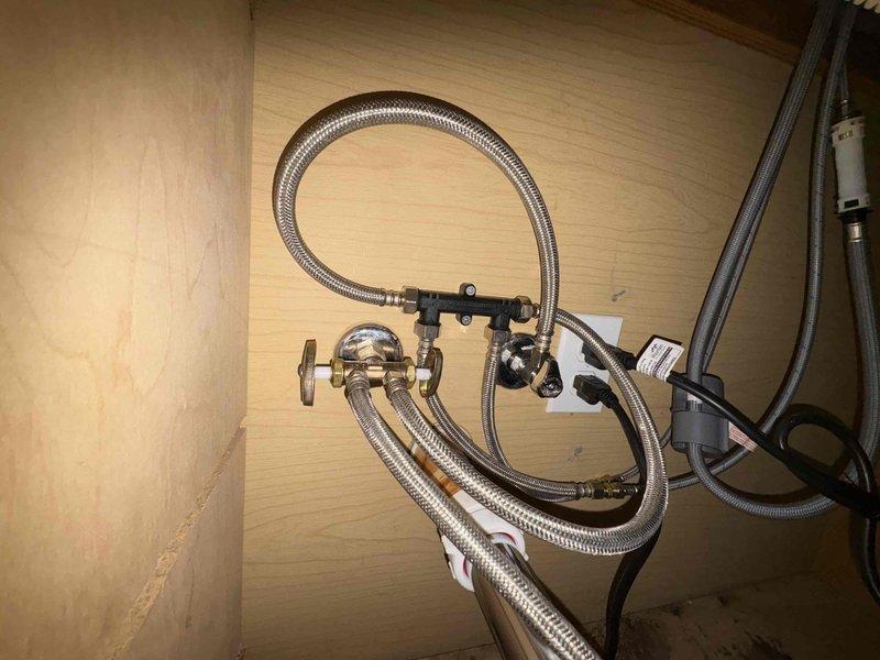 Replaced kitchen sink faucet with new single-handle pull-down model. Installed updated supply line connections under sink with braided stainless steel flexible hoses and new shut-off valve assembly. Customer advised that water hammer issue in lines and condensation/rust concerns on water heater unit will require additional evaluation and separate repair service.