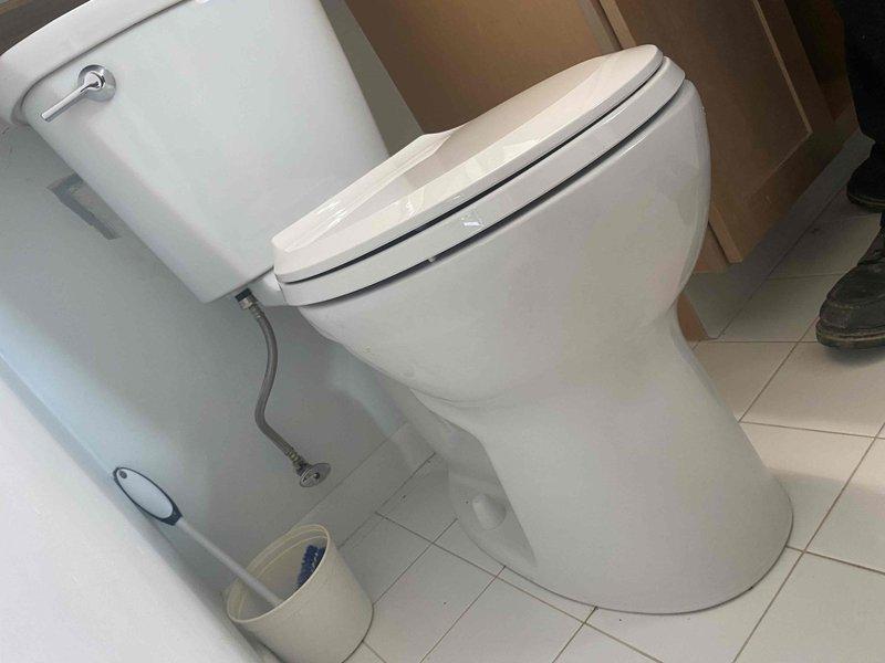 Completed installation of customer-supplied fixtures in upstairs bathroom, including toilet and shower head. Successfully installed white two-piece porcelain toilet with chrome flush lever and connected water supply line to wall plumbing, ensuring proper seating on existing tile flooring. Mounted brushed nickel multi-spray shower head with curved wall arm in tiled shower enclosure, verifying secure attachment and proper water flow. All fixtures tested and confirmed operational with no leaks detected.