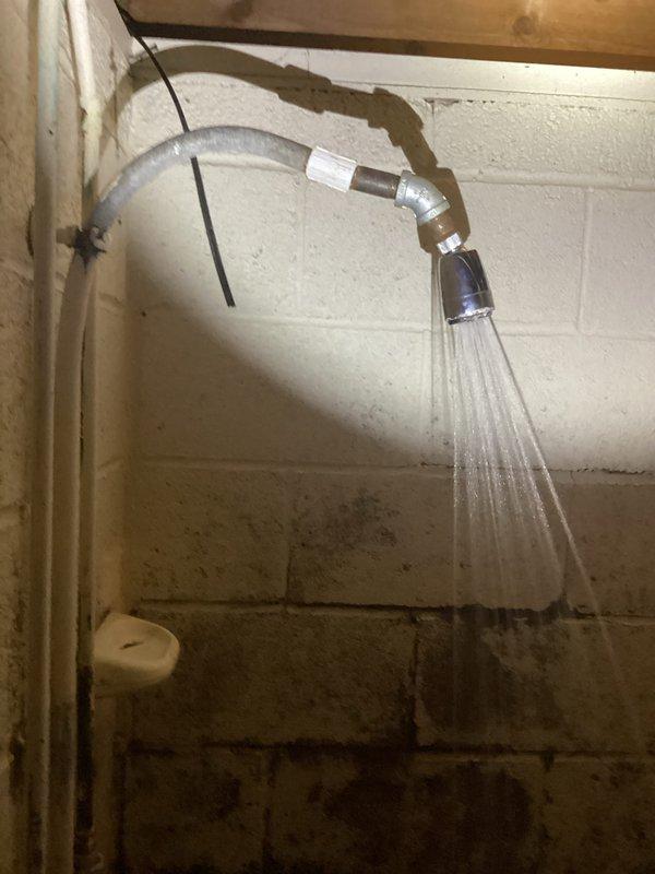 Responded to service call for non-operational sump pump in laundry area. Upon inspection, found sump pump basin located in basement utility space with evidence of significant moisture exposure and deteriorated conditions. Basin showed extensive corrosion, mineral deposits, and surface degradation indicating prolonged water contact and lack of maintenance. Pump failed to activate during testing. Diagnosed electrical supply issue and corroded pump components. Assessed surrounding area which displayed water staining on cinder block walls and aging plumbing infrastructure. Documented existing conditions with photographs for service records. Provided customer with findings and recommended replacement of pump unit due to extent of deterioration and to ensure reliable operation for laundry drainage system.