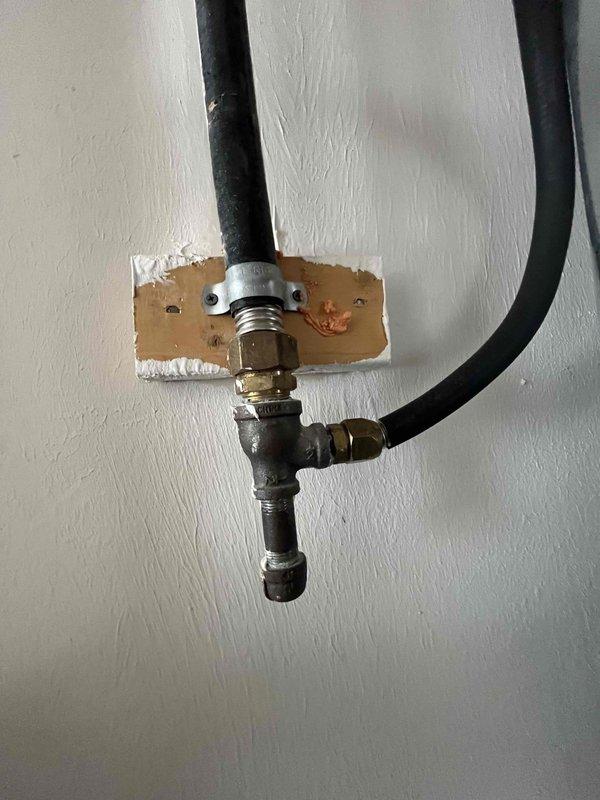 Serviced a 50-gallon electric water heater located in a utility closet alongside HVAC equipment. Inspected unit condition, connections, valves, and expansion tank mounting, verifying proper installation and operation of all plumbing components. Documented system configuration including copper piping, shutoff valves, and flex connections for service records.