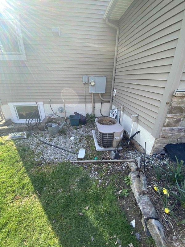 Performed HVAC system replacement estimate for 22-year-old gas furnace and air conditioning system. The existing heating unit has failed and is no longer operational, while the outdoor condensing unit shows significant age-related wear. Documented current equipment configuration including outdoor AC condenser positioned on gravel pad with proper clearances, electrical service connections, and overall system layout to provide comprehensive replacement recommendations for both heating and cooling components.