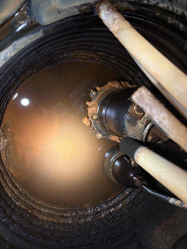 Performed comprehensive maintenance service on dual sump pump system including primary and secondary pumps. Inspected both sump basins, which showed signs of sediment accumulation and discolored water indicating extended operational use. Evaluated pump mechanisms for corrosion and mineral buildup on metal components, noting visible deterioration on float assemblies and discharge piping. Serviced battery backup system to ensure emergency operation capability during power outages. Verified proper discharge pipe connections and electrical cord routing within both basins.