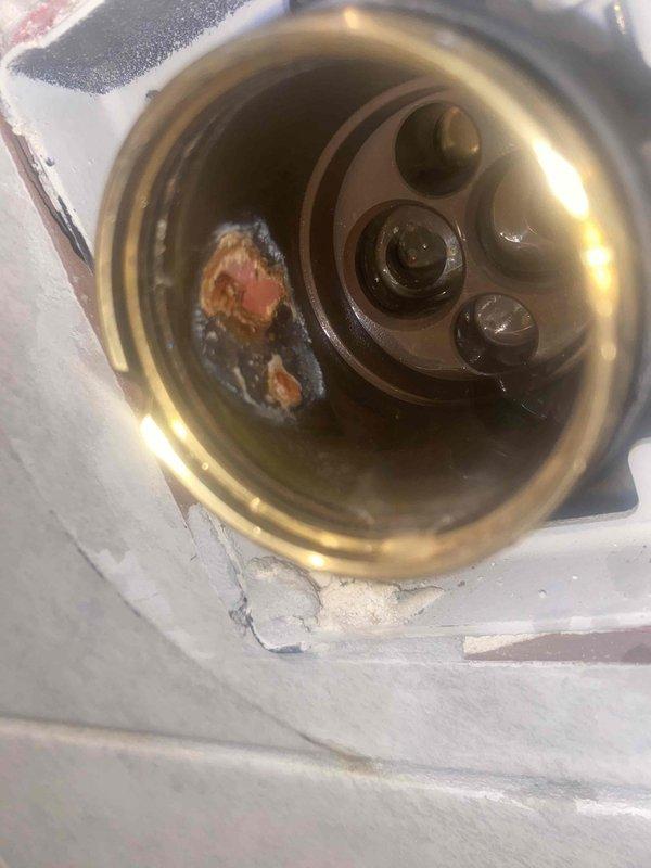 Completed return service to install previously sold Delta multi-turn shower cartridge. Removed existing worn cartridge showing significant mineral buildup and debris accumulation in valve body, thoroughly cleaned valve housing and seating surfaces, and installed new Delta replacement cartridge with fresh O-rings. Tested operation of temperature control and water flow, verified proper handle function, and confirmed no leaks at trim plate assembly.