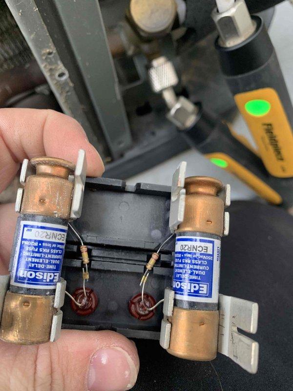 Completed routine cooling maintenance member visit on residential HVAC system. Inspected and photographed electrical components including fuse holder with Edison EON-20 fuses, verified proper fuse integrity and connections. Examined blower motor assembly, checking motor mounting, drive gear mechanism, and operational components for wear and proper function. All systems found to be operating within normal parameters.