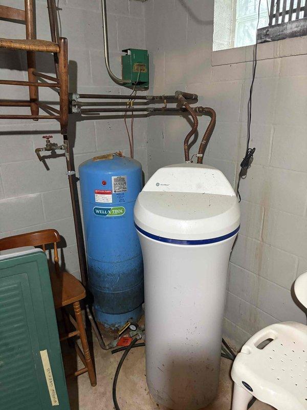 Conducted on-site assessment for ductless mini-split air conditioning system installation in residence currently equipped with baseboard hot water heating and no existing cooling system. Evaluated basement mechanical room and lower level areas to determine optimal placement for indoor air handler units and exterior condenser location, documenting existing utility infrastructure including well pressure tank and water treatment equipment. Assessed electrical service capacity, potential refrigerant line routing paths through basement joists, and clearance requirements for equipment installation to provide comprehensive estimate for complete ductless AC system.