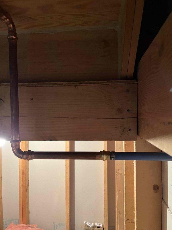 Removed existing 80-gallon electric water heater and successfully installed new 50-gallon State brand electric water heater. Modified plumbing access by removing back plywood panel to facilitate proper copper water line connections. Completed all necessary piping connections, installed expansion tank with isolation valves, and verified system operation upon completion.