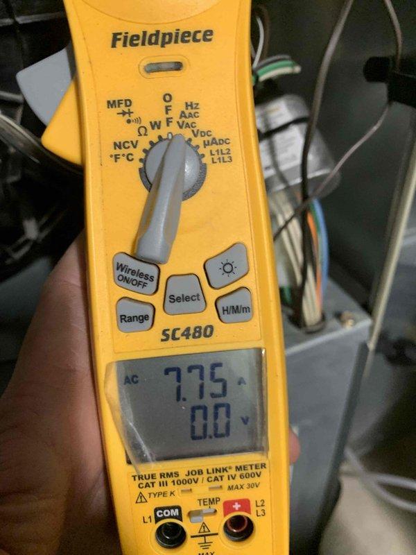 Completed heating maintenance club visit for ductless minisplit system. Performed electrical diagnostics using multimeter, verifying voltage readings at 775V AC and checking system operation. Inspected and documented fuse assembly showing dual 250V AC rated fuses in good working condition with proper wire connections intact.