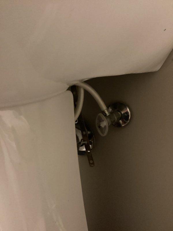 Completed plumbing membership inspection at residential property. Inspected bathroom angle stop valve and supply line connections for proper operation and leaks, verified toilet supply plumbing integrity. Examined kitchen double-basin sink, pull-down faucet assembly, and under-counter shut-off valves to ensure all fixtures were functioning correctly with no visible leaks or deficiencies.