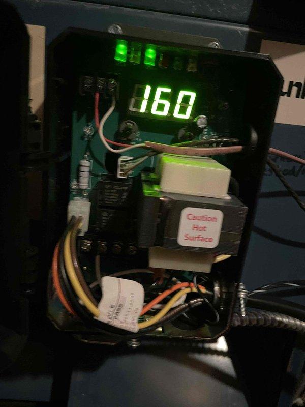 Responded to callback for overheating complaint. Inspected heating system control board and found temperature setpoint display reading 160°F and limit control showing 232°F. Verified transformer operation and checked all wire connections at terminal blocks. Reviewed control sequence operation with digital display reading 0.78 and confirmed all indicator lights functioning properly. System controls and safety devices operating within normal parameters at time of inspection.