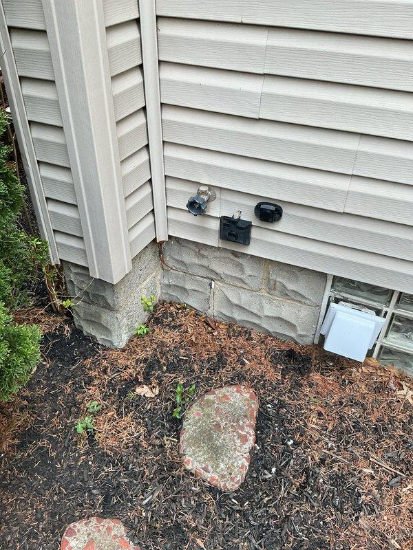 Completed routine plumbing membership inspection at residential property. Inspected bathroom fixtures including bathtub, shower controls, chrome spout, and drain assembly, confirming all components were functioning properly and in good condition. Examined exterior plumbing connections and utility access points on foundation for proper operation and noted no issues requiring immediate attention.