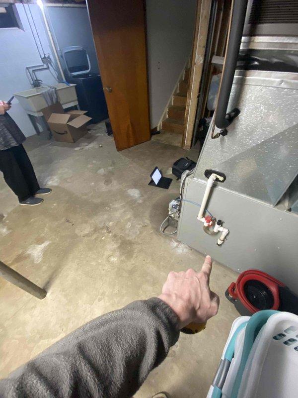 Conducted HVAC system replacement estimate for residential property with existing oil furnace and non-operational air conditioning system. Evaluated basement mechanical room conditions, documented current equipment configuration including failed AC unit and existing ductwork infrastructure, and assessed installation requirements for new HVAC system replacement in unfinished basement space with concrete flooring and exposed joists.