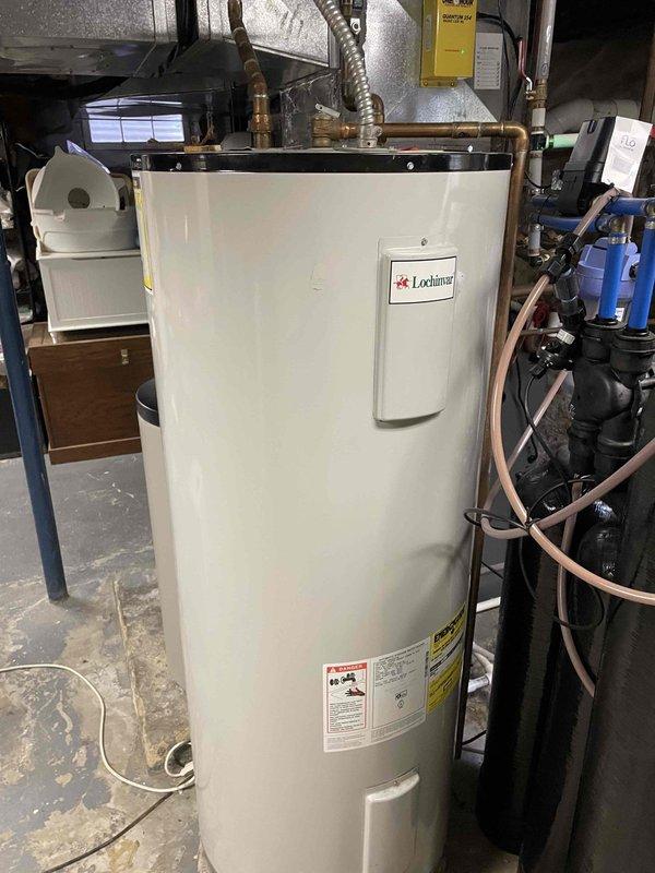 Returned to property to install two powered anode rods in Lochinvar water heater unit. Successfully removed existing anode rods and replaced with powered anode rod system to provide enhanced corrosion protection and extend tank lifespan. Verified all electrical connections, tested system operation, and confirmed proper installation of both units with secure mounting at top of water heater tank.