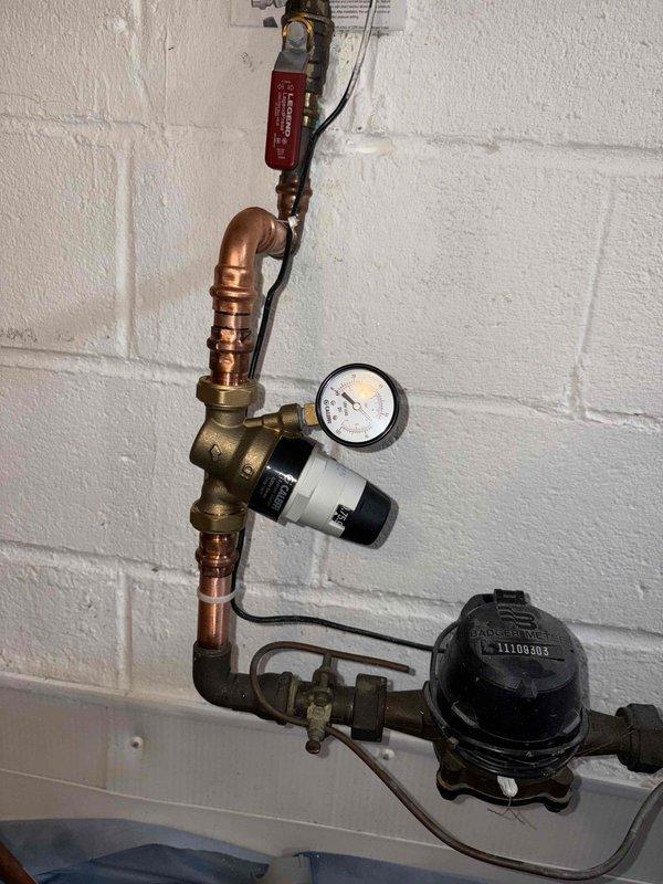 Replaced malfunctioning pressure reducing valve on main water supply line. Installed new pressure reducing valve with integrated pressure gauge to maintain proper water pressure throughout the building, ensuring protection of downstream plumbing fixtures and appliances from excessive pressure damage.