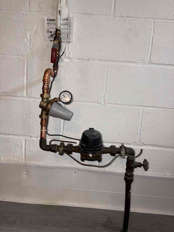 Replaced malfunctioning pressure reducing valve on main water supply line. Installed new pressure reducing valve with integrated pressure gauge to maintain proper water pressure throughout the building, ensuring protection of downstream plumbing fixtures and appliances from excessive pressure damage.