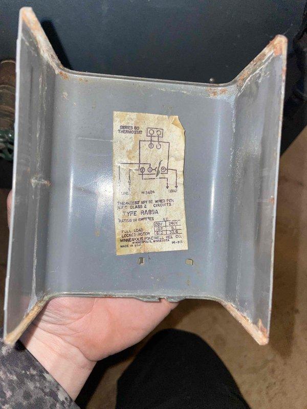 Completed cooling maintenance on residential HVAC system and identified potential thermostat malfunction requiring replacement at the air handler. Inspected outdoor condensing unit positioned on concrete pad and documented equipment condition, noting age-related wear and corrosion on metal components and weathered manufacturer labeling.
