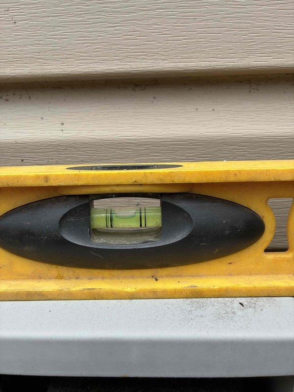 Completed full HVAC system installation including new American Standard condensing unit positioned and leveled on gravel pad against exterior wall. Unit was properly secured, leveled to manufacturer specifications, and all connections verified for optimal system performance.