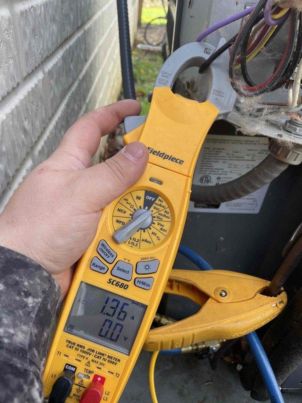 Responded to service call for outdoor condensing unit producing humming noise with warm air discharge after unit was operated with protective cover in place. Upon arrival, performed diagnostic electrical testing using clamp meter on condenser unit components, measuring amperage draw and verifying proper electrical parameters. Inspected outdoor unit's louvered grille assembly, internal condenser coils, and fan motor operation to assess any damage from restricted airflow condition caused by cover obstruction during operation.