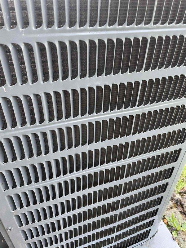 Responded to service call for outdoor condensing unit producing humming noise with warm air discharge after unit was operated with protective cover in place. Upon arrival, performed diagnostic electrical testing using clamp meter on condenser unit components, measuring amperage draw and verifying proper electrical parameters. Inspected outdoor unit's louvered grille assembly, internal condenser coils, and fan motor operation to assess any damage from restricted airflow condition caused by cover obstruction during operation.