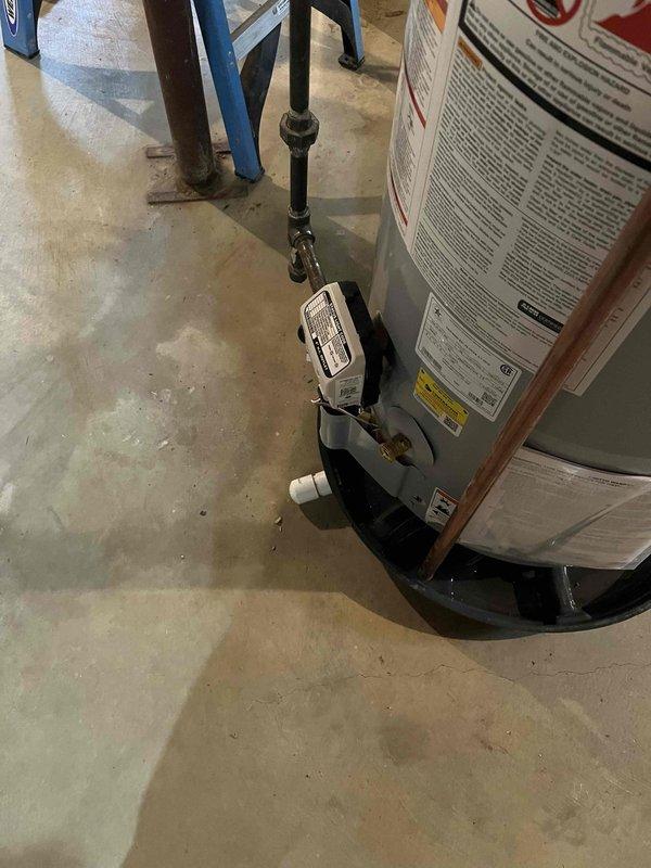 Installed 50-gallon A.O. Smith standard vent gas water heater with drip pan capped per customer request to eliminate above-ground tripping hazard. Unit installed with proper gas connections, verified burner ignition and flame pattern, and confirmed all safety labels and specifications are visible on exterior of tank.