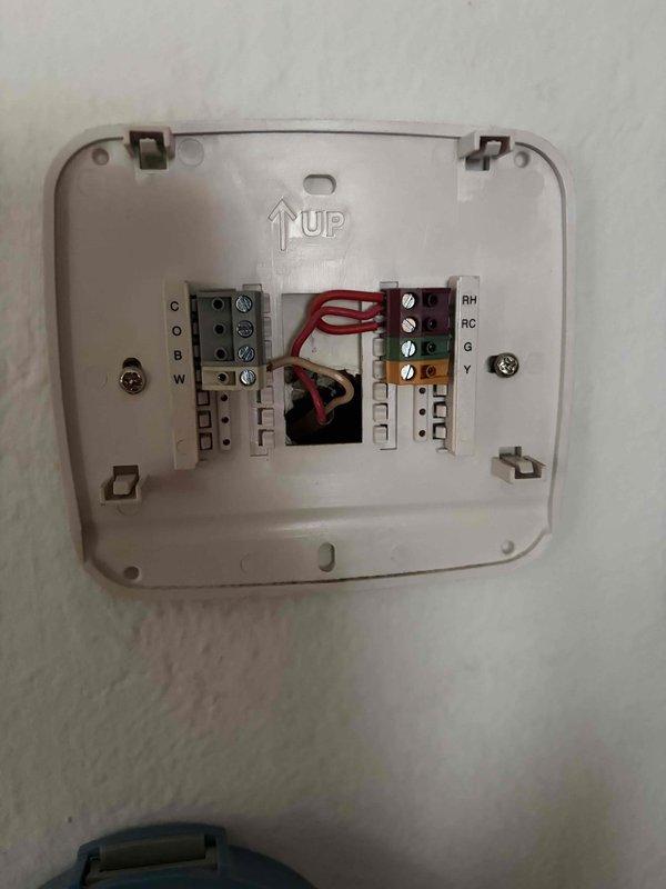 Responded to service call for persistent water leakage at boiler system. Identified leaking valve on water supply line feeding into boiler unit, which was discovered as a new issue following recent boiler repair work. Inspected system components, documented conditions with photographs of thermostat wiring configuration and electrical junction box in mechanical space, and assessed plumbing connections to determine source of water accumulation on floor. Leak isolated to feed line valve requiring replacement to resolve ongoing water discharge issue.
