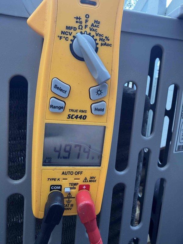 Performed routine cooling maintenance member visit on Trane air conditioning unit (Model A4AC3030A1000AA, Serial 20392NP5BF). Conducted system diagnostics using digital multimeter, recording temperature reading of 497°F at measured component. Completed standard inspection of 3-ton AC unit manufactured September 2020, verified unit specifications including 208/230V single-phase operation at 16.0 amps with R-410A refrigerant charge of 25 oz.