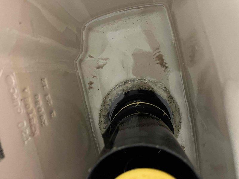 Performed routine maintenance flush on tanked water heater to remove sediment buildup and ensure optimal performance. Inspected drain pan and surrounding components, noting accumulation of debris and mineral deposits that were addressed during the service. Unit returned to normal operation with improved efficiency.