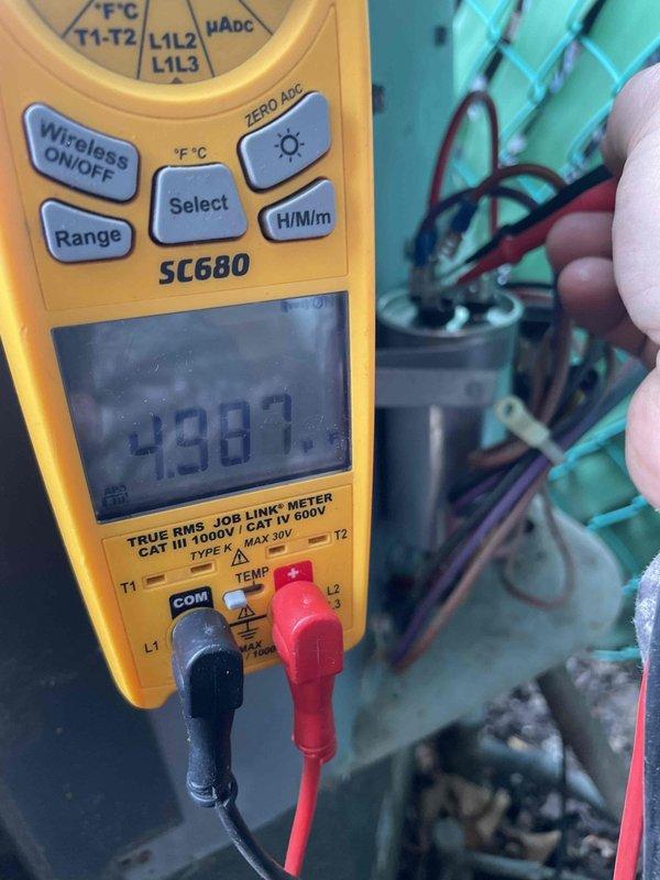 Responded to service call for air conditioning unit not cooling properly with outdoor fan motor inoperative and unusual noise reported. Upon arrival, confirmed compressor was running but condenser fan motor failed to operate. Performed diagnostic testing using digital multimeter to check electrical components. Measured capacitor with readings indicating failure outside acceptable range. Inspected fan motor windings and confirmed motor had seized, preventing blade rotation. Removed defective dual run capacitor and failed condenser fan motor. Installed replacement capacitor with proper microfarad rating and new condenser fan motor matching original specifications. Verified all electrical connections were secure and tested system operation. Unit now cooling properly with condenser fan operating at correct speed and no abnormal sounds present.