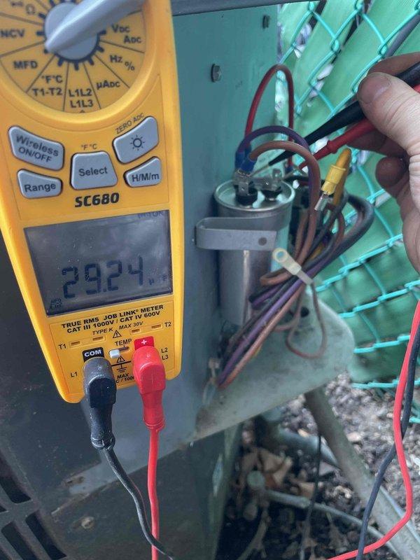 Responded to service call for air conditioning unit not cooling properly with outdoor fan motor inoperative and unusual noise reported. Upon arrival, confirmed compressor was running but condenser fan motor failed to operate. Performed diagnostic testing using digital multimeter to check electrical components. Measured capacitor with readings indicating failure outside acceptable range. Inspected fan motor windings and confirmed motor had seized, preventing blade rotation. Removed defective dual run capacitor and failed condenser fan motor. Installed replacement capacitor with proper microfarad rating and new condenser fan motor matching original specifications. Verified all electrical connections were secure and tested system operation. Unit now cooling properly with condenser fan operating at correct speed and no abnormal sounds present.