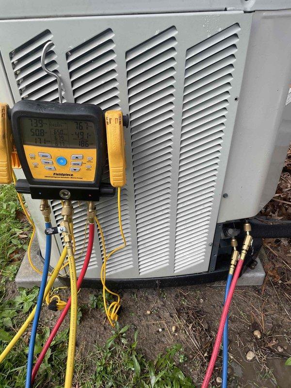 Responded to no cooling complaint on 2014 Goodman 2.5-ton air conditioning unit. Upon arrival, connected manifold gauges to service ports and performed system diagnostics. Unit was circulating air but not producing cool air. Verified thermostat operation and confirmed cooling mode selected. Checked refrigerant pressures and temperatures, identified low refrigerant charge as primary issue. Added refrigerant to manufacturer specifications, monitored system performance until proper cooling restored. Unit operating within normal parameters at time of departure.