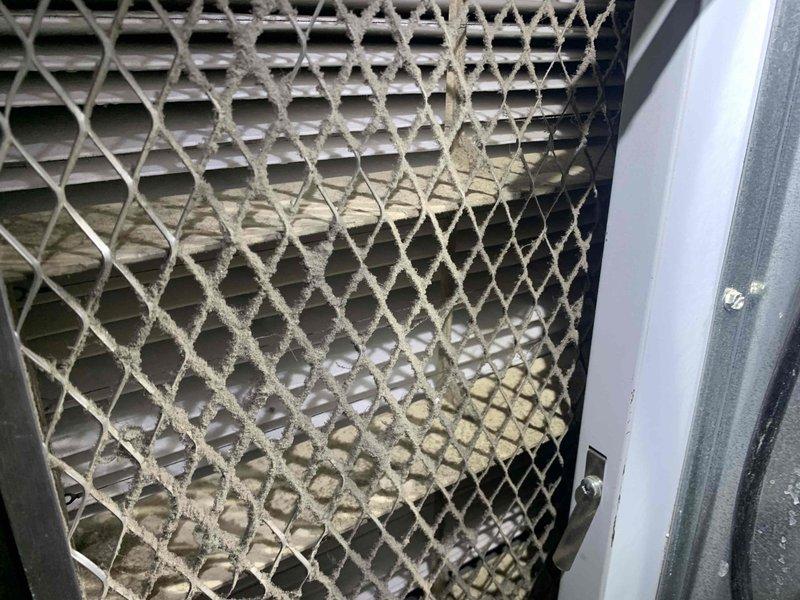 Completed cooling maintenance club visit on residential HVAC system. Performed comprehensive system inspection and diagnostics using digital multimeter to verify electrical readings and system performance. Inspected outdoor condenser unit, noting accumulated debris and environmental buildup on protective grille and coil surfaces that could impact efficiency if not addressed during routine maintenance intervals.