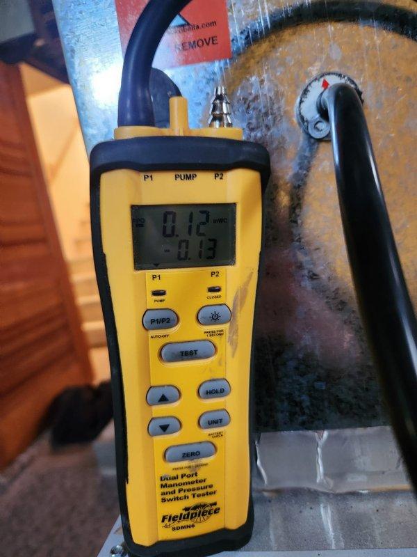 Completed cooling maintenance club visit on air handler system. Upon inspection, discovered significant ice buildup on evaporator coil with temperature reading of 62°F, indicating restricted airflow or refrigerant issue. Measured static pressure at 0.12 inches water column, confirming airflow restriction. Documented conditions with photos showing frozen coil and pressure readings for further diagnostic evaluation and necessary repairs.