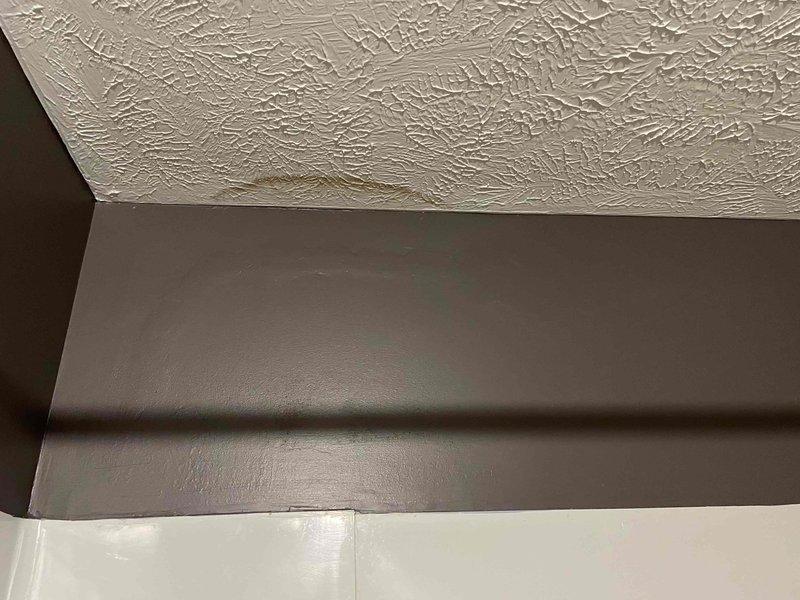 Responded to complaint of musty odor and visible moisture in upstairs bathroom of 32-year-old home. Utilized moisture detection equipment to assess affected areas, identifying water intrusion at wall-to-wall corner and ceiling-to-wall junction. Inspection revealed discoloration and staining on textured drywall surfaces, indicating active moisture penetration requiring further investigation to locate source of leak.