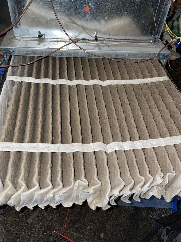 # Emergency No Heat Call - Furnace Diagnostic

Responded to emergency no heat call for furnace with unknown age. Upon arrival, performed complete system diagnostic to identify cause of heating failure. 

Inspection revealed heavily soiled air filter with significant dust and dirt accumulation throughout pleated media, restricting airflow to system. Noted moisture condensation present on interior metal panels of air handler compartment. Accessed internal electrical components and control boards to perform voltage testing using digital multimeter. Measured system voltages at multiple test points to verify proper electrical supply and component operation. Inspected wiring connections, control board, and safety circuits for proper function.

Identified dirty filter as contributing factor to system shutdown, likely triggering safety limit switch due to restricted airflow and overheating conditions. Replaced air filter with new pleated media to restore proper system airflow. Verified all ele